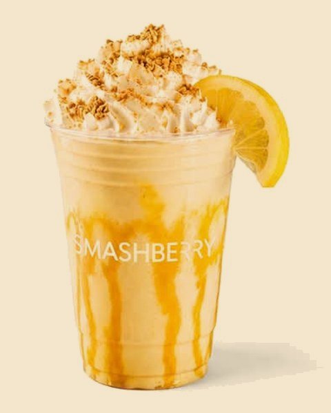 Lemon Meringue dirty smoothie, whipped cream, crumbled biscuit and a lemon slice.