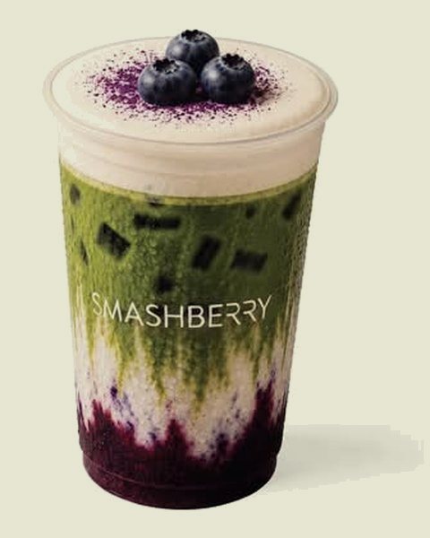 Blueberry Vanilla iced matcha latte: blueberry layer, matcha and foam, blueberries on top.