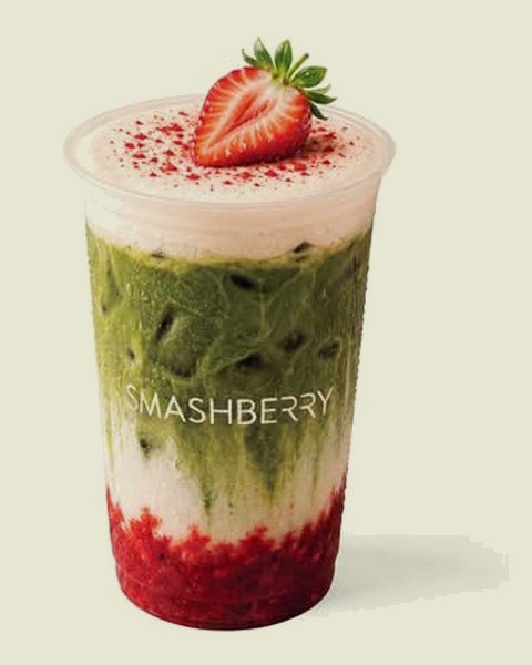Strawberry Vanilla iced matcha latte: strawberry layer, matcha and foam, a strawberry on top.