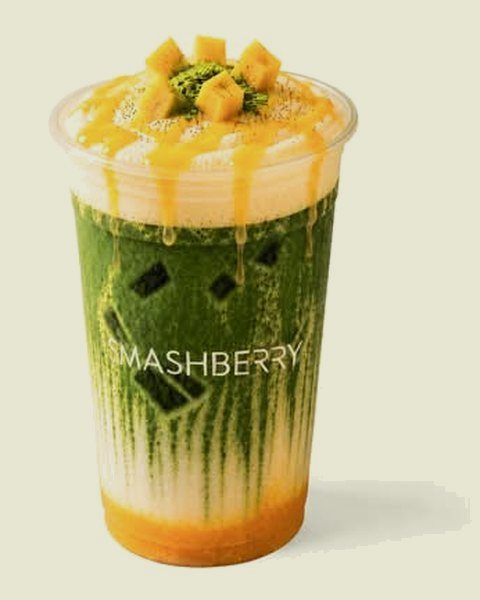 Yuzu Mango iced matcha latte: mango layer, matcha and foam, mango on top.