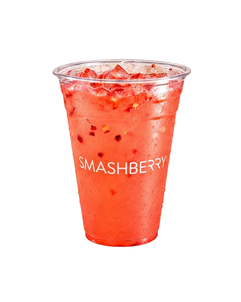 Raspberry Hibiscus refresher, coral, with red fruit pieces, Smashberry cup.