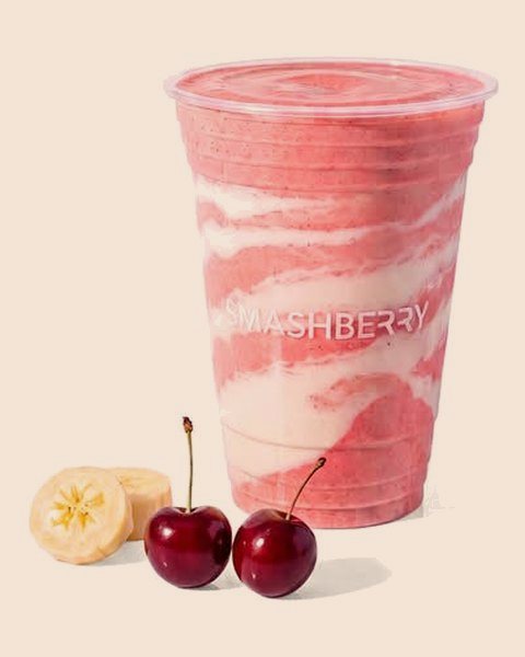 Recovery Lab smoothie, swirled pink, with cherries and banana.